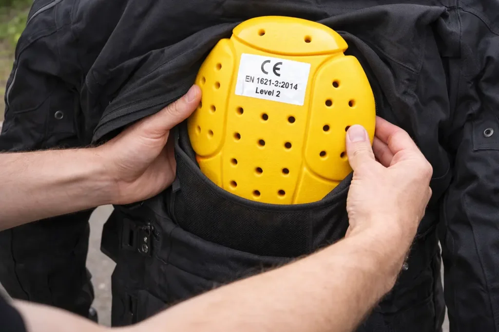 CE Rating Explained: What Do Motorcycle Armor Levels Mean? 5 Inserting back protector into jacket